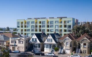 Merritt Crossing is a Green Point rated and LEED Platinum certified affordable housing building for seniors, a model of sustainable design in an urban area of Oakland in the Bay Area.