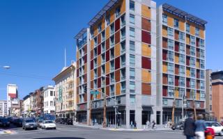 The Plaza Apartments in San Francisco was the first new permanent housing for formerly homeless residents; located in the South of Market neighborhood, the affordable housing complex achieves a sustainable goal of being certified LEED Silver and includes supportive services for residents.